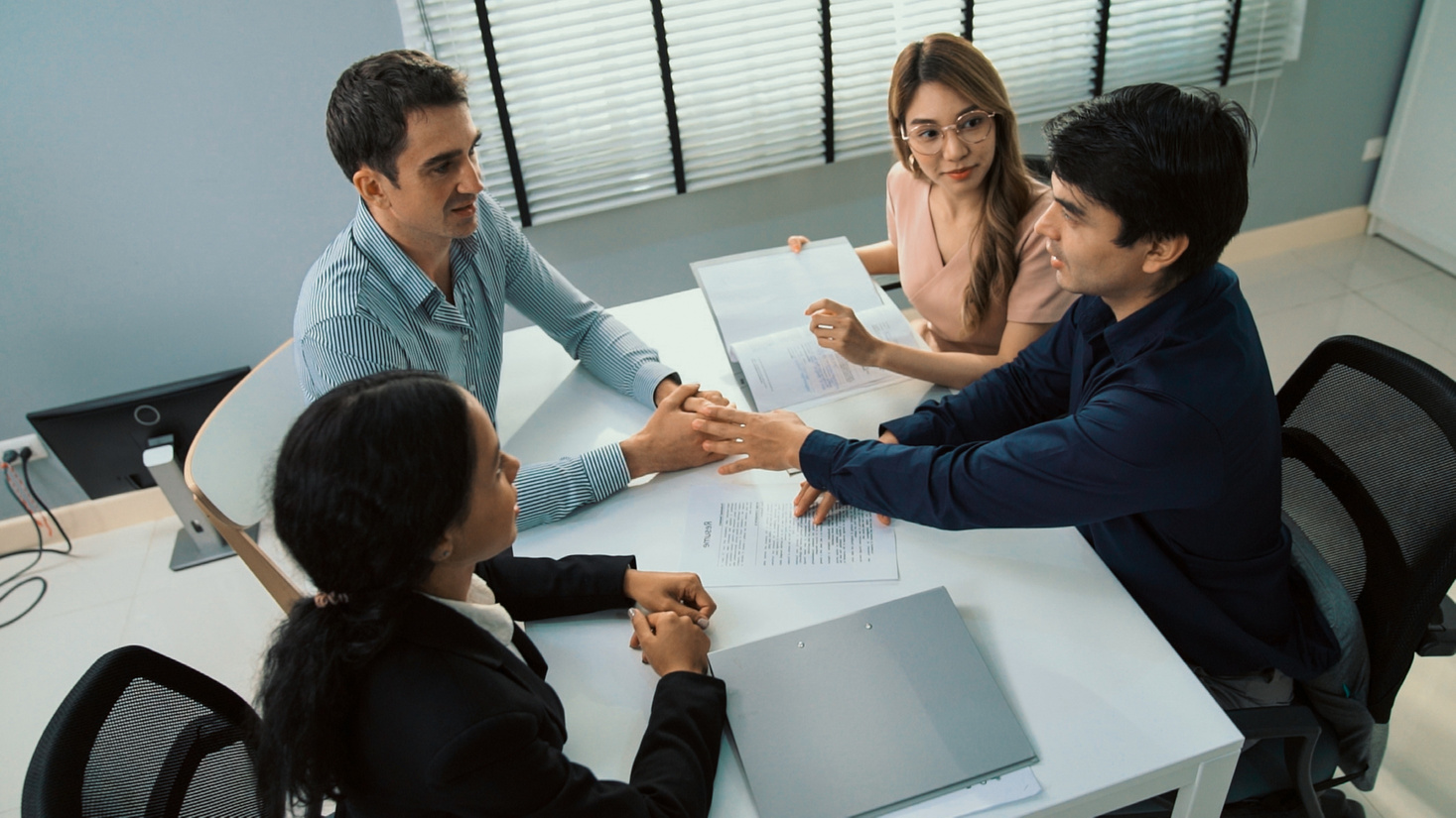Commercial, agreement deal signed by competent people of several ethnicities.