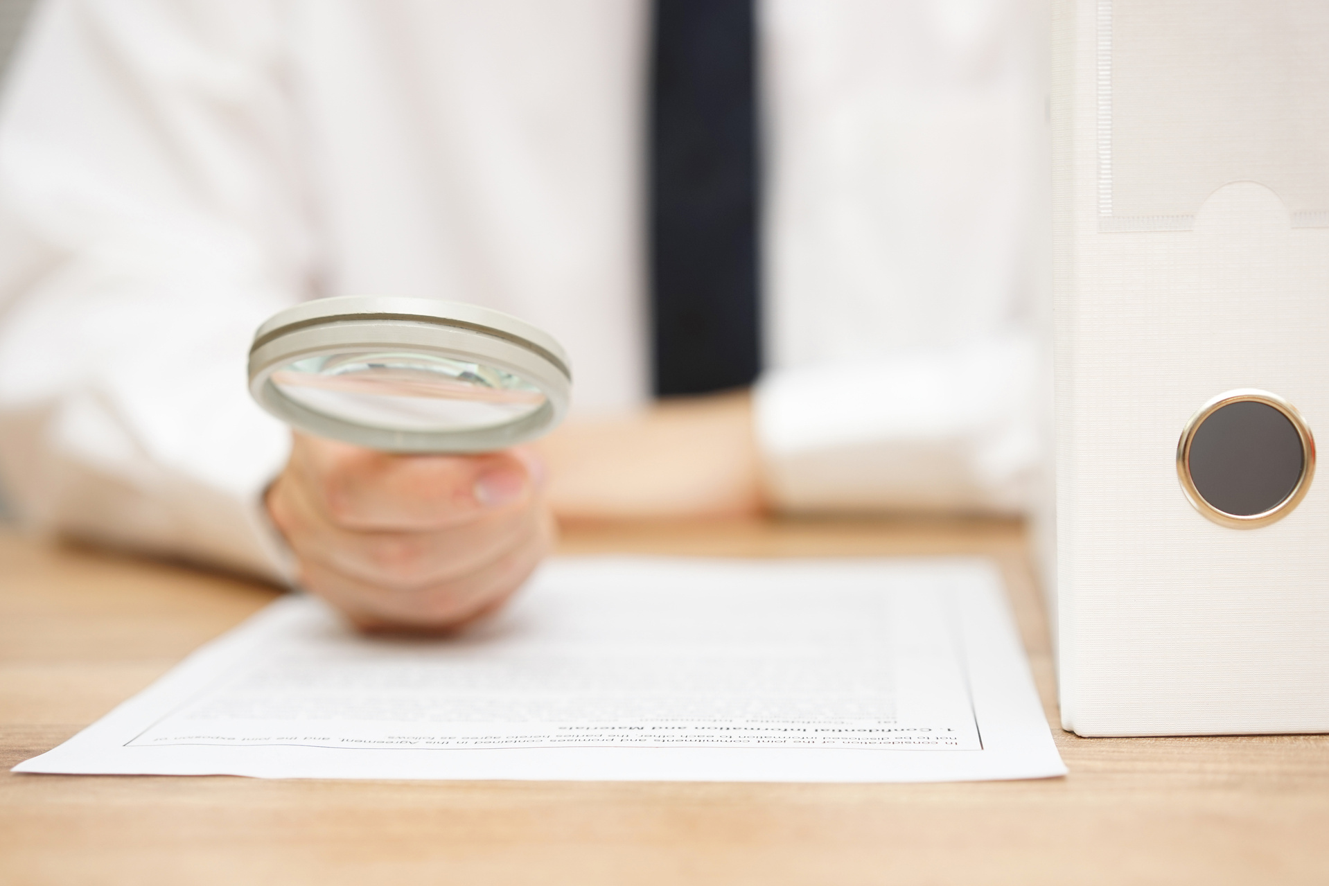 businessman is reviewing company documentation on workplace, due diligence concept